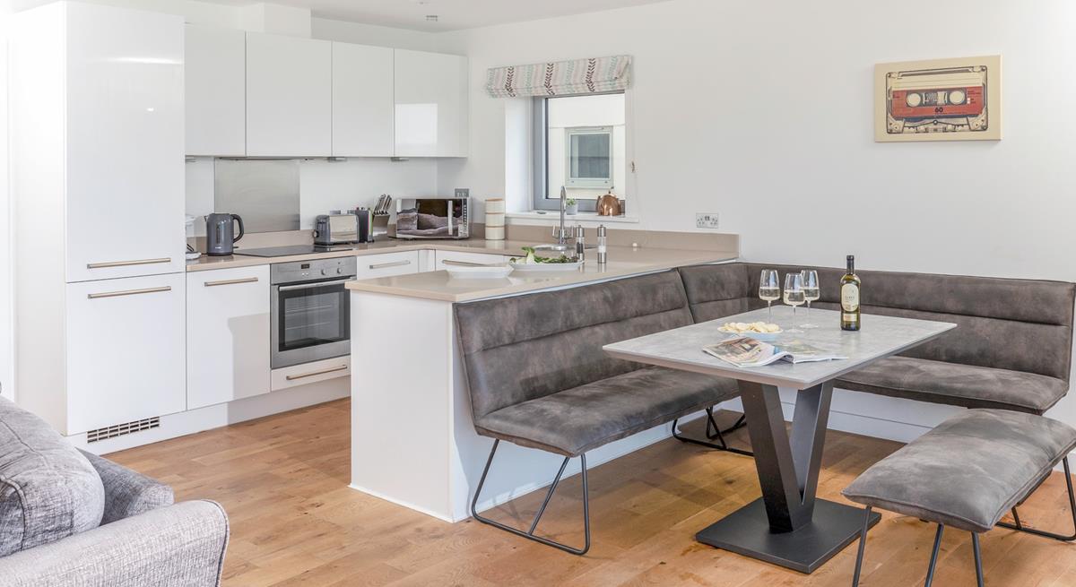 The kitchen is modern and sleek with space for the whole family to sit around the dining table.