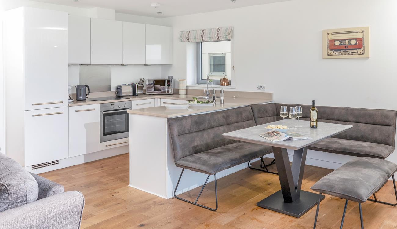 The kitchen is modern and sleek with space for the whole family to sit around the dining table.