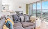 Enjoy the sea views from the sofa and dining table. - Thumbnail Image