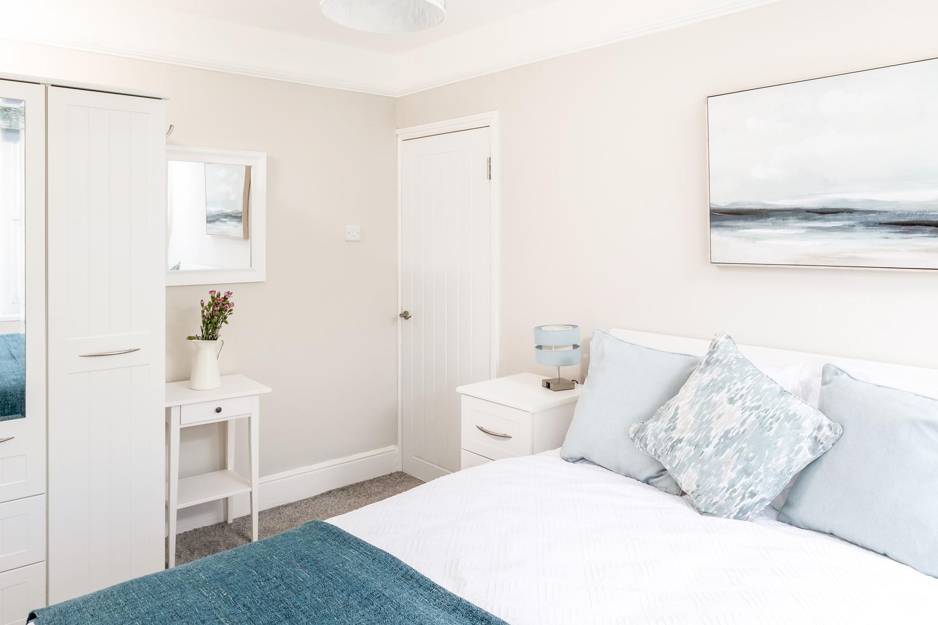 Bedroom 2 has calming blue and white hues.
