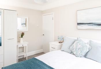 Bedroom 2 has calming blue and white hues.