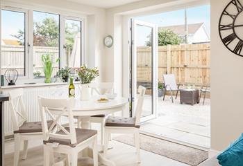 Open the patio doors to let the fresh air into the light and airy dining space.