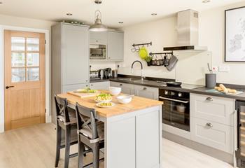 The modern beautifully presented kitchen is well-equipped for all your culinary needs.