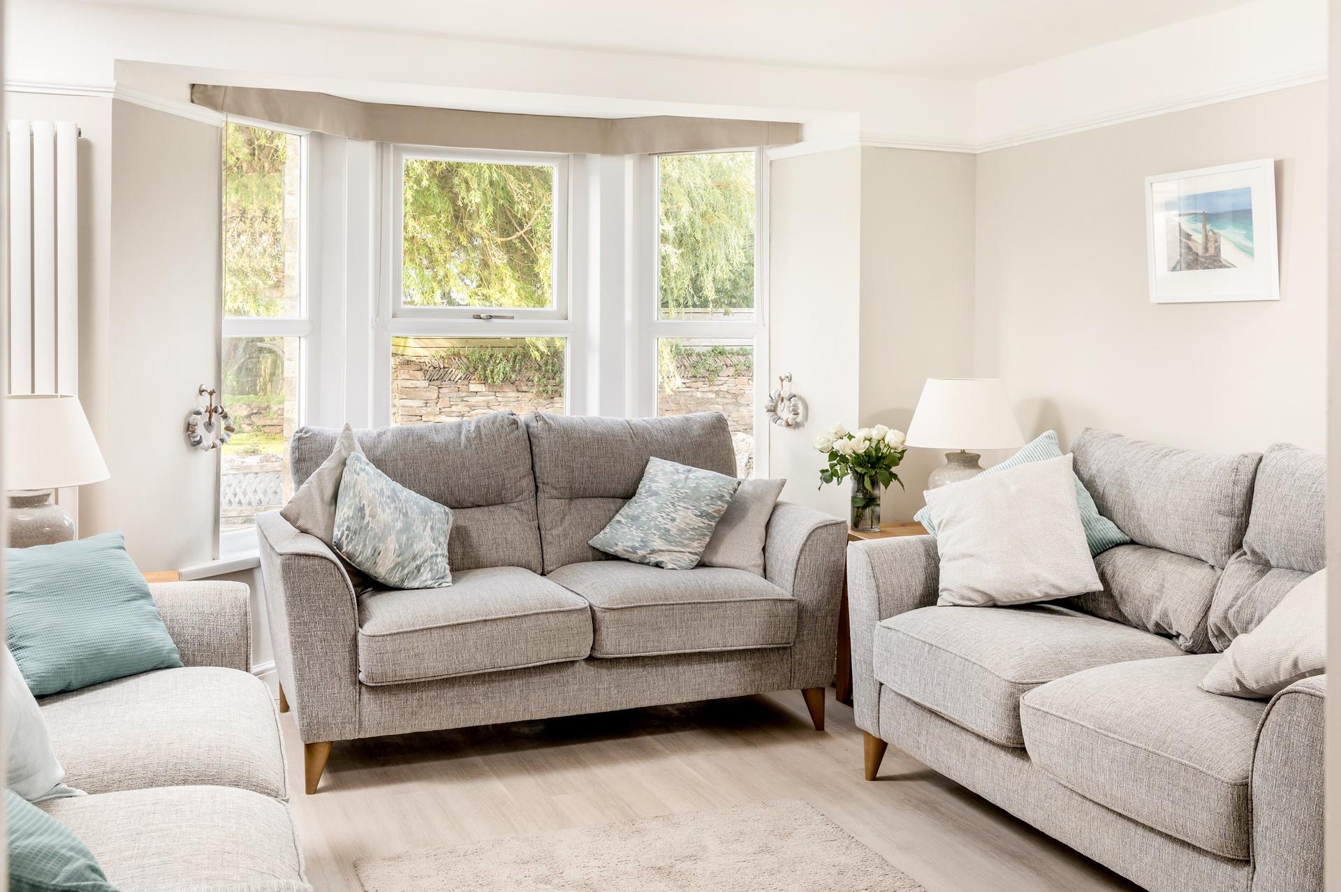The cosy sitting room offers a lovely space for a family movie night.