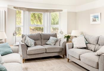 The cosy sitting room offers a lovely space for a family movie night.