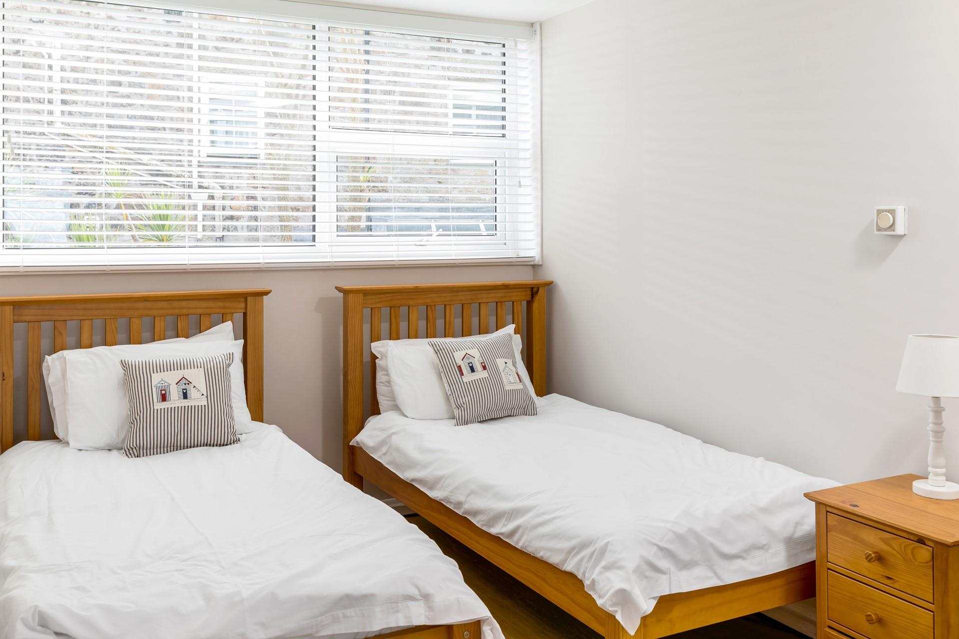 Bedroom 2 has comfortable twin beds to tuck into after a long day.
