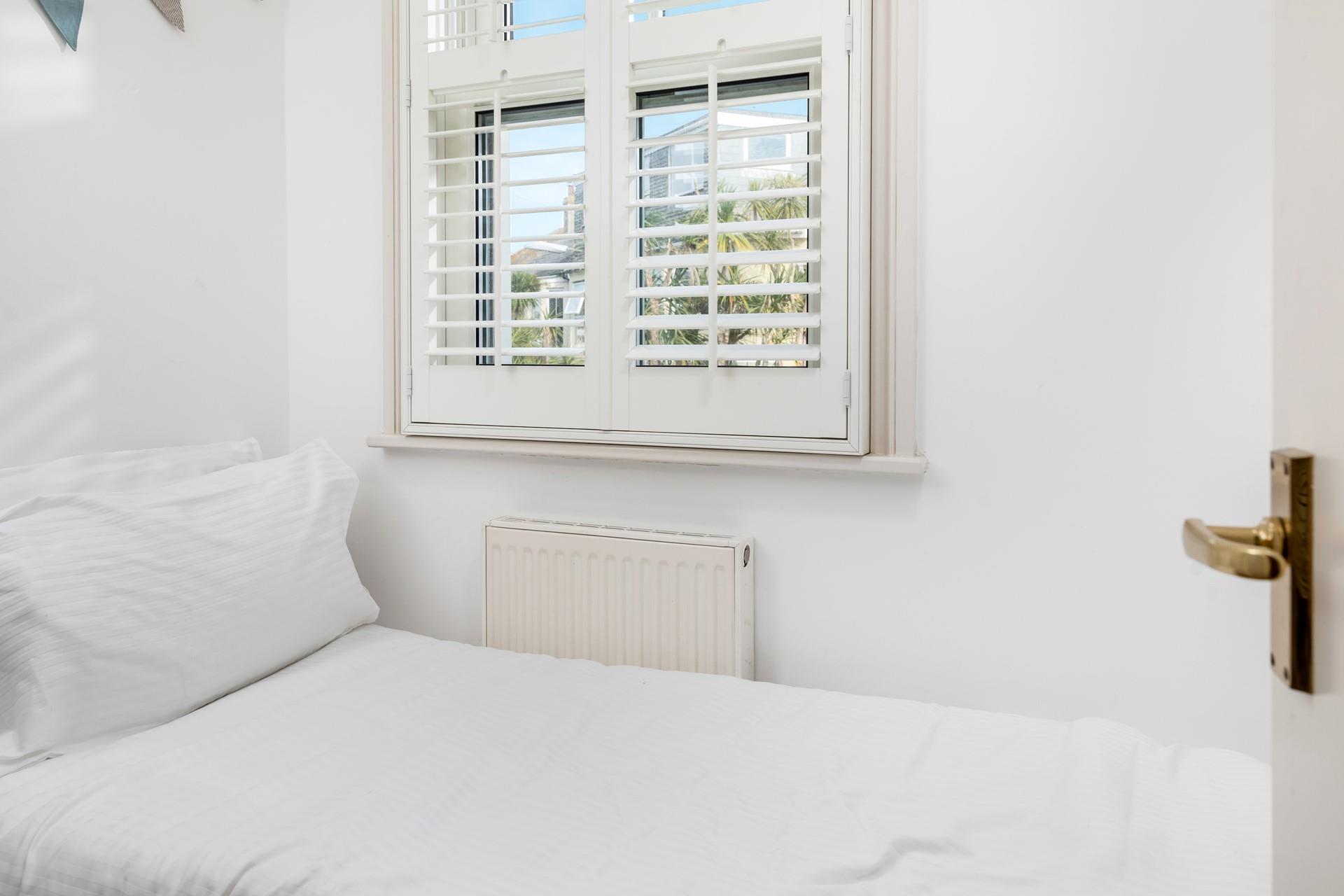 Bedroom 3 has a small single bed suitable for a little one.