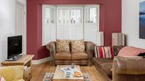 The colourful sitting room is the perfect base to come back to after a day on the beach.