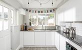 The modern and sleek kitchen is well-equipped for cooking tasty meals. - Thumbnail Image