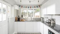 The modern and sleek kitchen is well-equipped for cooking tasty meals.