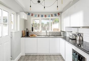 The modern and sleek kitchen is well-equipped for cooking tasty meals.