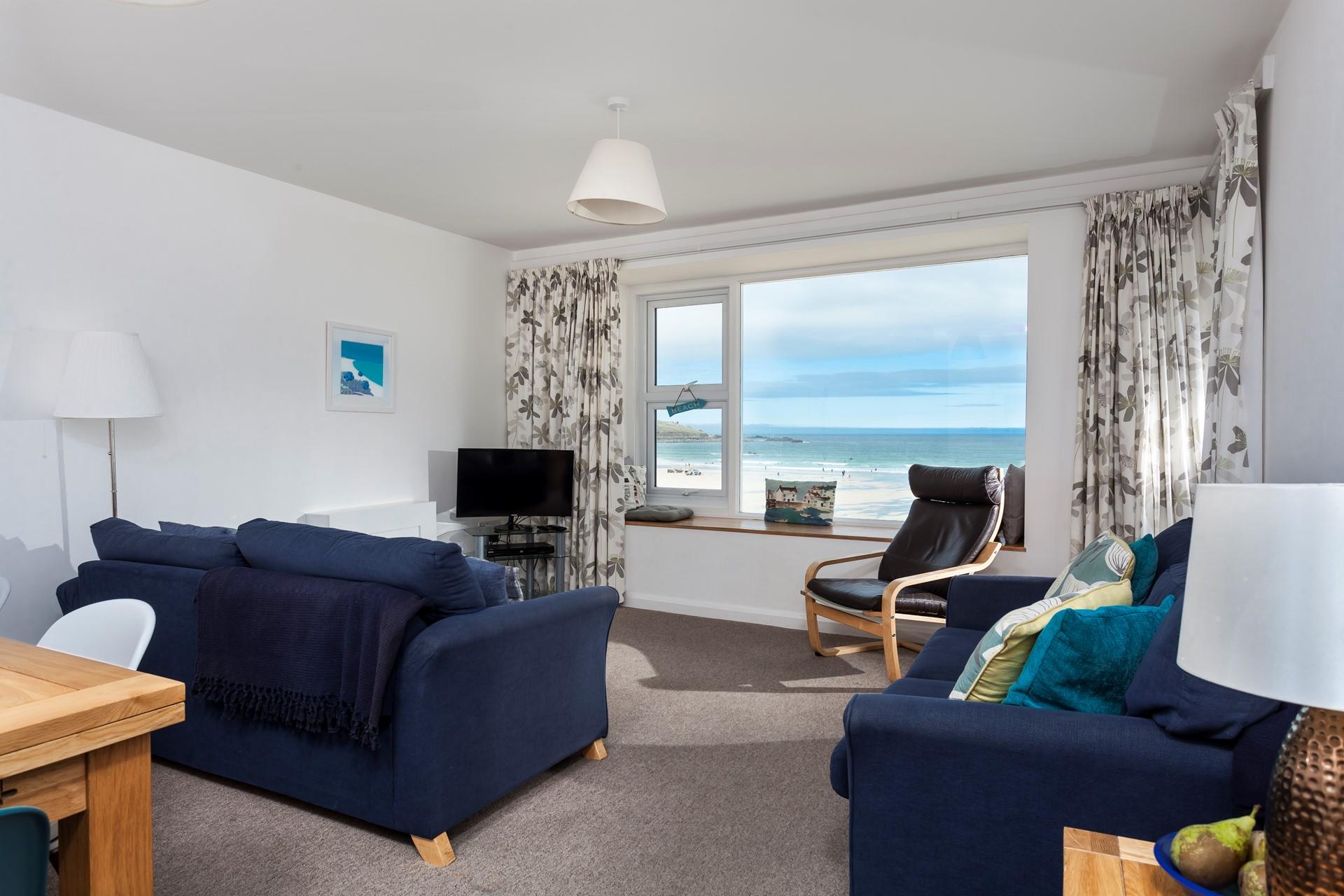 Sink into the sofa and spend hours gazing out at the waves rolling onto the beach.