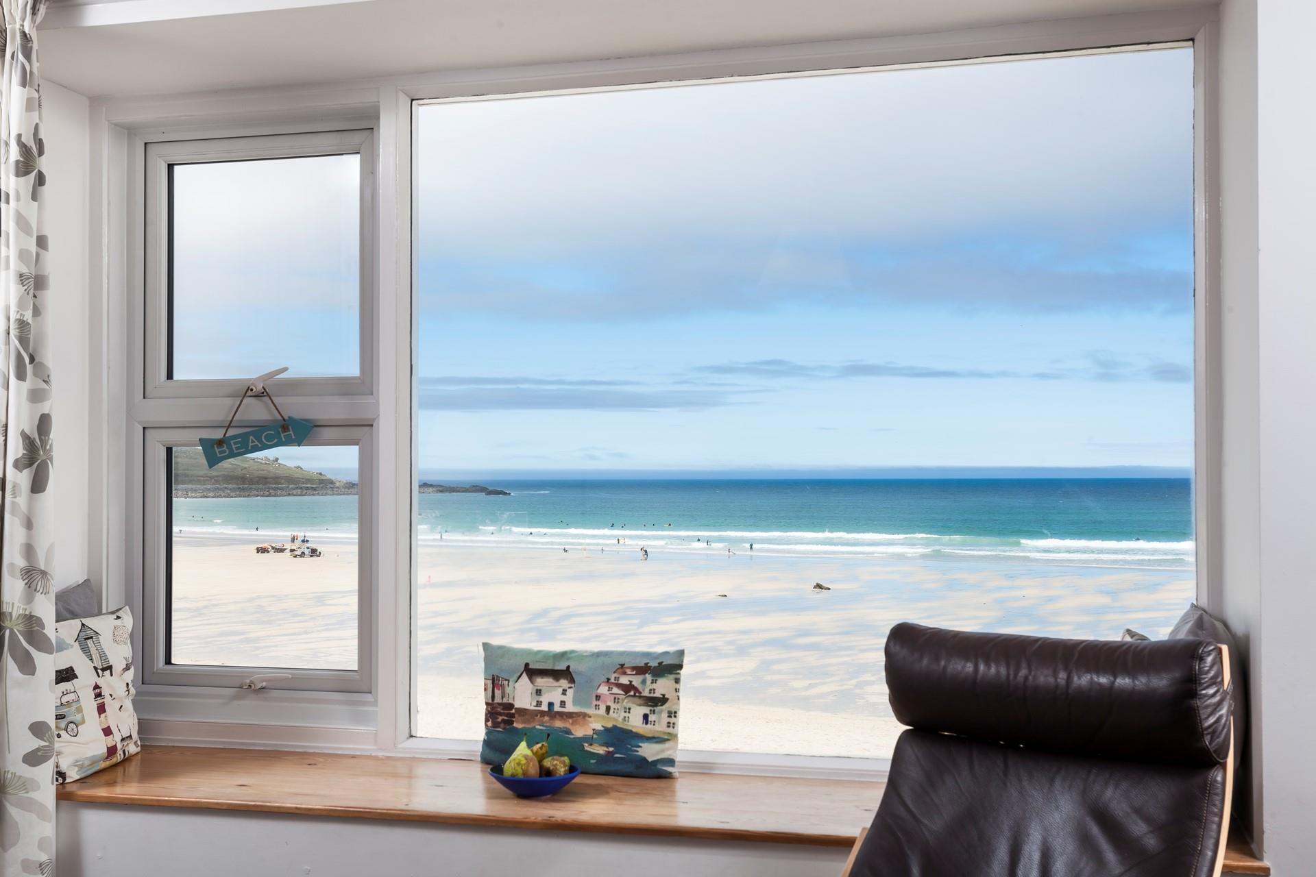 Sit in front of the window with a cup of tea watching the comings and goings on the beach.