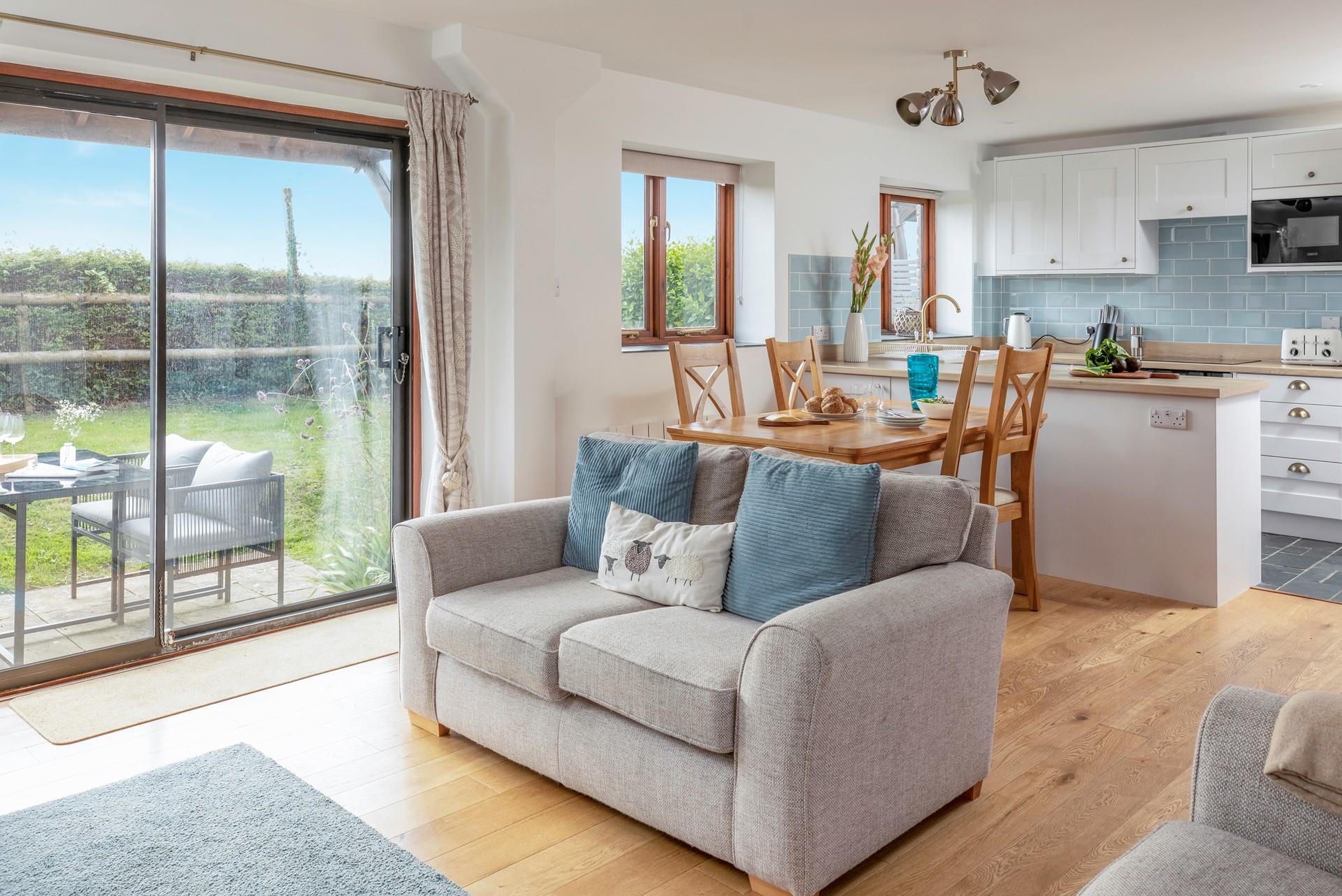 The light and airy living area looks out over the garden and has lovely countryside views.