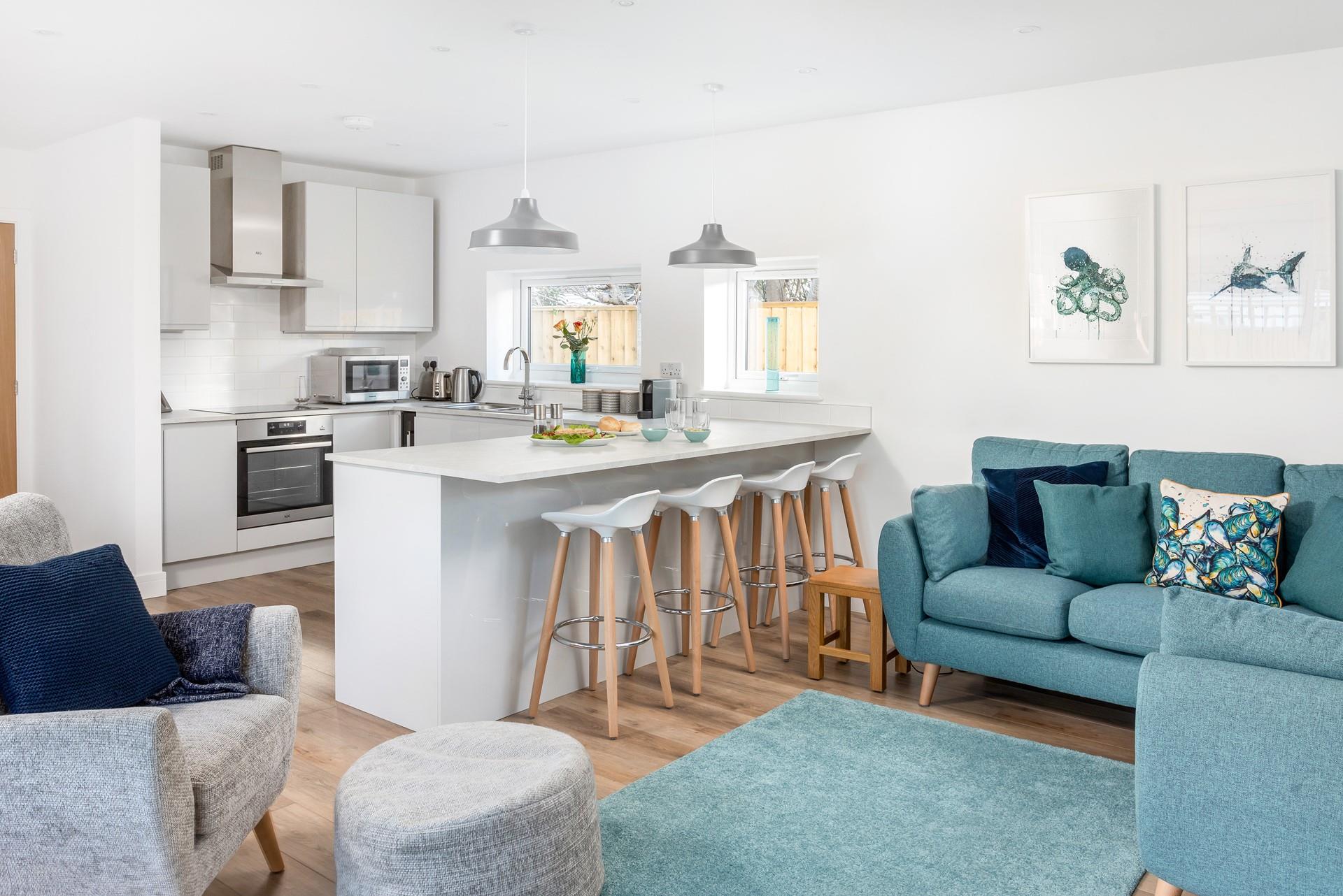 The living space is open plan and includes the kitchen, sitting and dining area, perfect for entertaining.