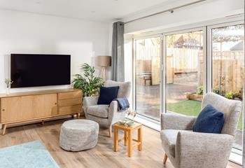 Grey armchairs and matching footstools offer pure relaxation and comfort after days of exploring.