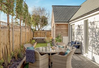 The outside area has been tastefully planted, and gorgeous rattan furniture is perfect for alfresco dining.