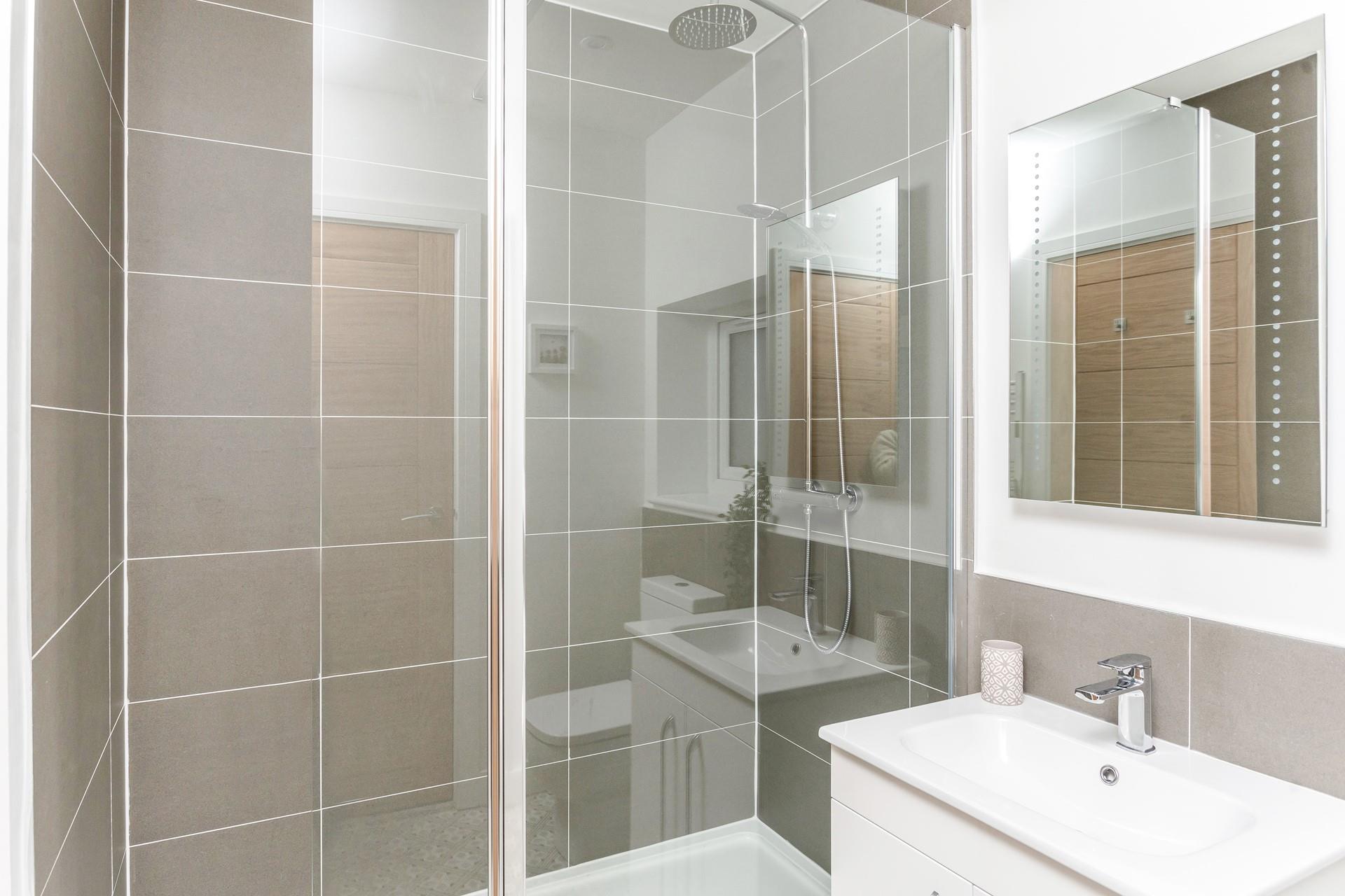 The shower room has a large fully enclosed rainfall shower for washing off sandy toes after beach days.
