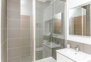 The shower room has a large fully enclosed rainfall shower for washing off sandy toes after beach days.