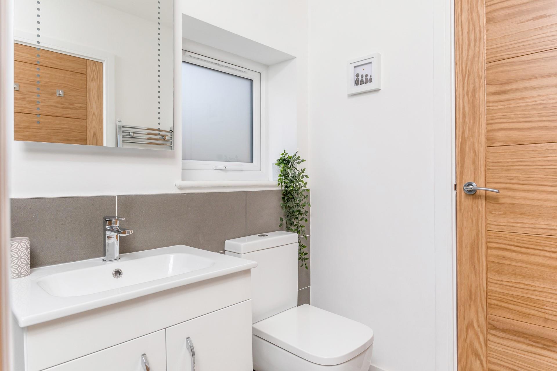 The washer/dryer is located in the shower room.