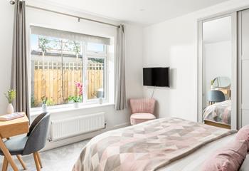 Bedroom 1 has blush pink decor and a spacious king size bed for a dreamy night's sleep.