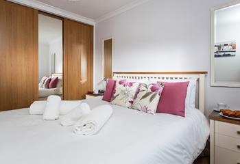 Bedroom 2 is decorated with lovely fuchsia pink cushions.
