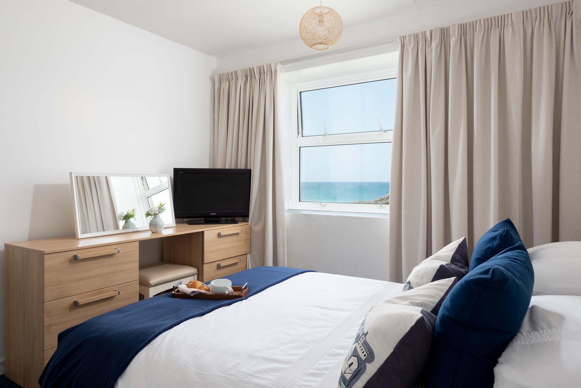 Bedroom 2 features a king size bed and beautiful sea views to wake up to.