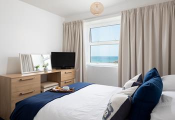 Bedroom 2 features a king size bed and beautiful sea views to wake up to.