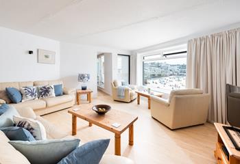 The sitting room has tones of blue reflecting the close proximity to the sea.