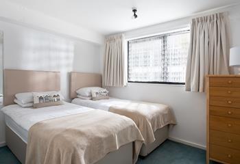 Bedroom 2 has twin beds perfect for adults or children to rest after an exhausting day exploring the coastline.