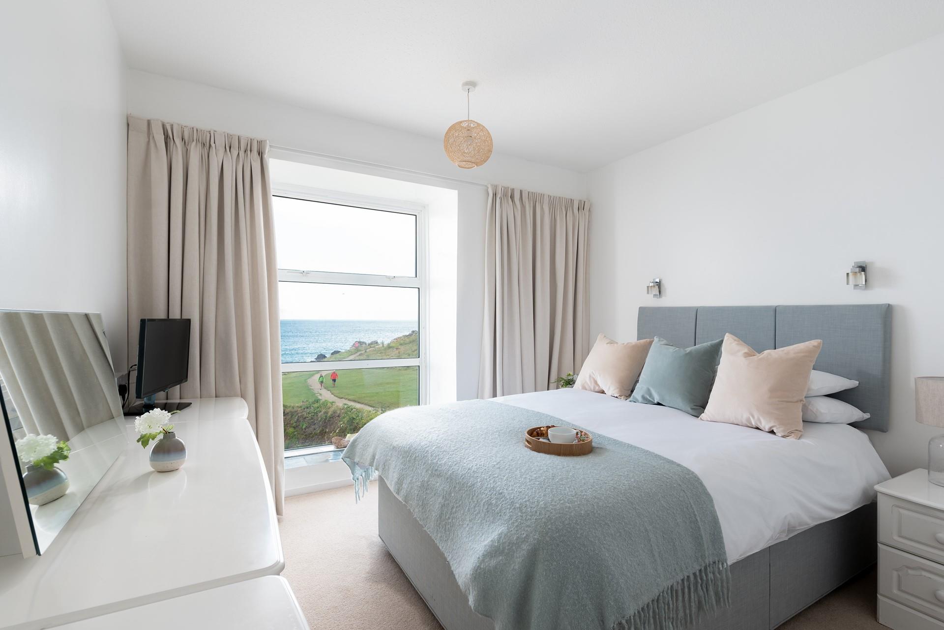 The modern and stylish bedroom features a king size bed to sink into each night.