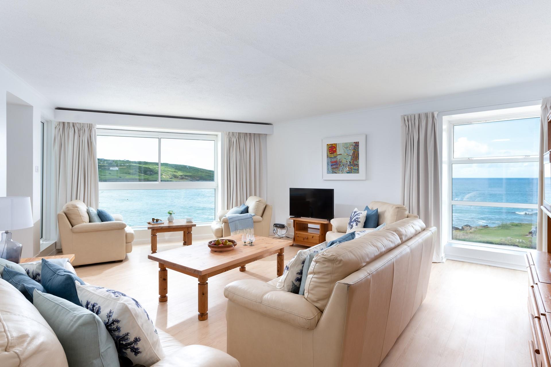 The spacious living area has far-reaching views of the beautiful azure waters of Porthmeor beach.