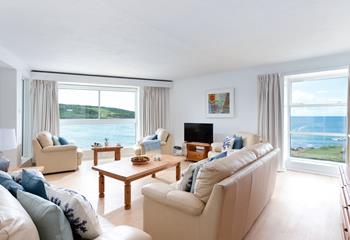 The spacious living area has far-reaching views of the beautiful azure waters of Porthmeor beach.