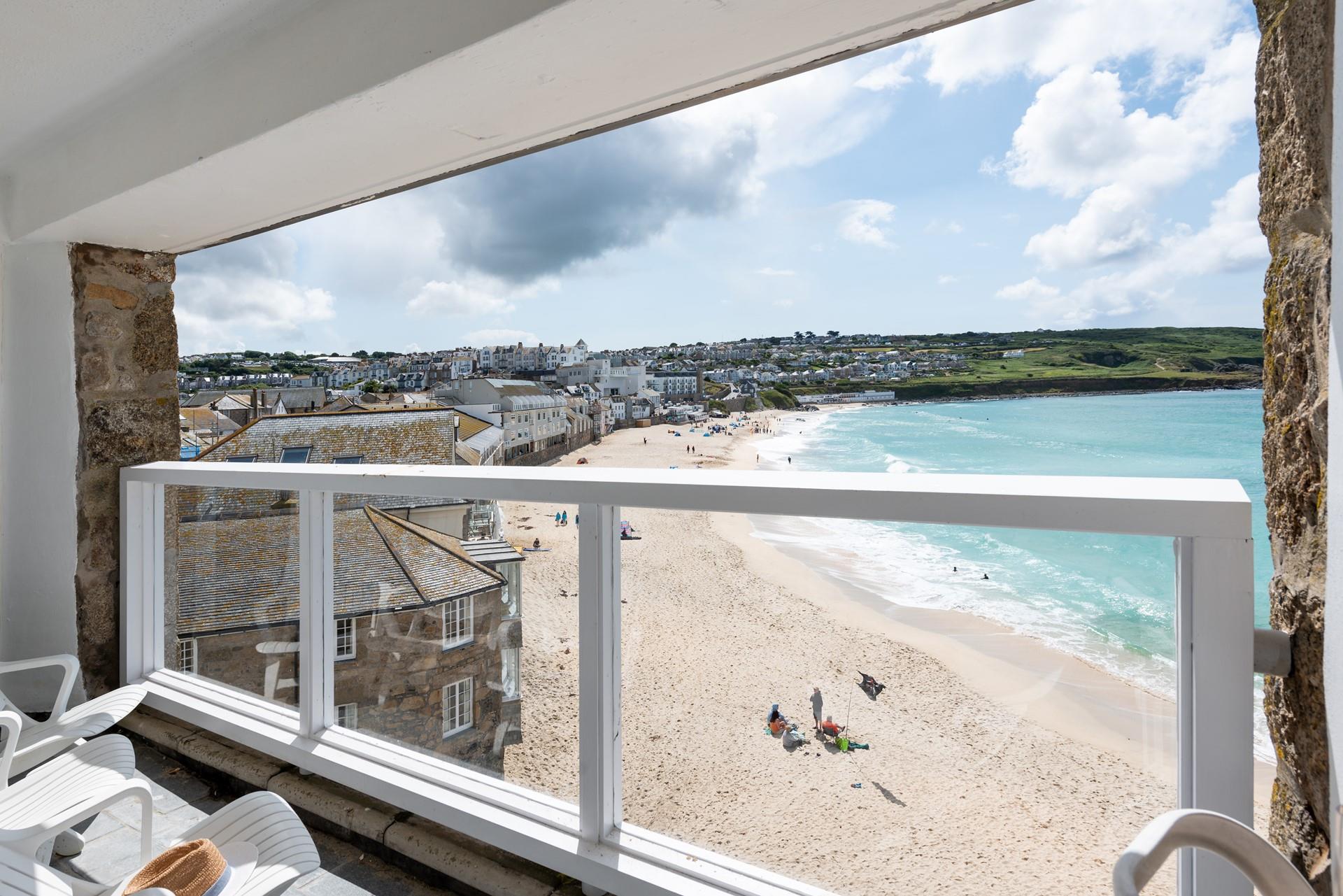 Relax and unwind on the balcony with a glass of something cold in hand.