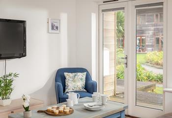 Let the fresh air in through the patio doors that lead out to the decking. 