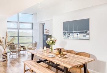 Dine together as a family in the spacious open plan living space, filled with natural light and warmth on a summer's day.