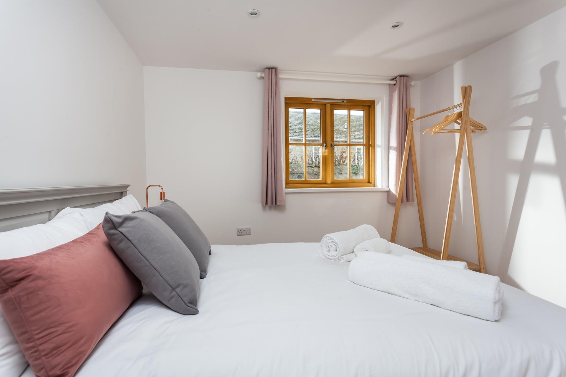 The spacious king size bed will provide you with a cosy night's sleep.