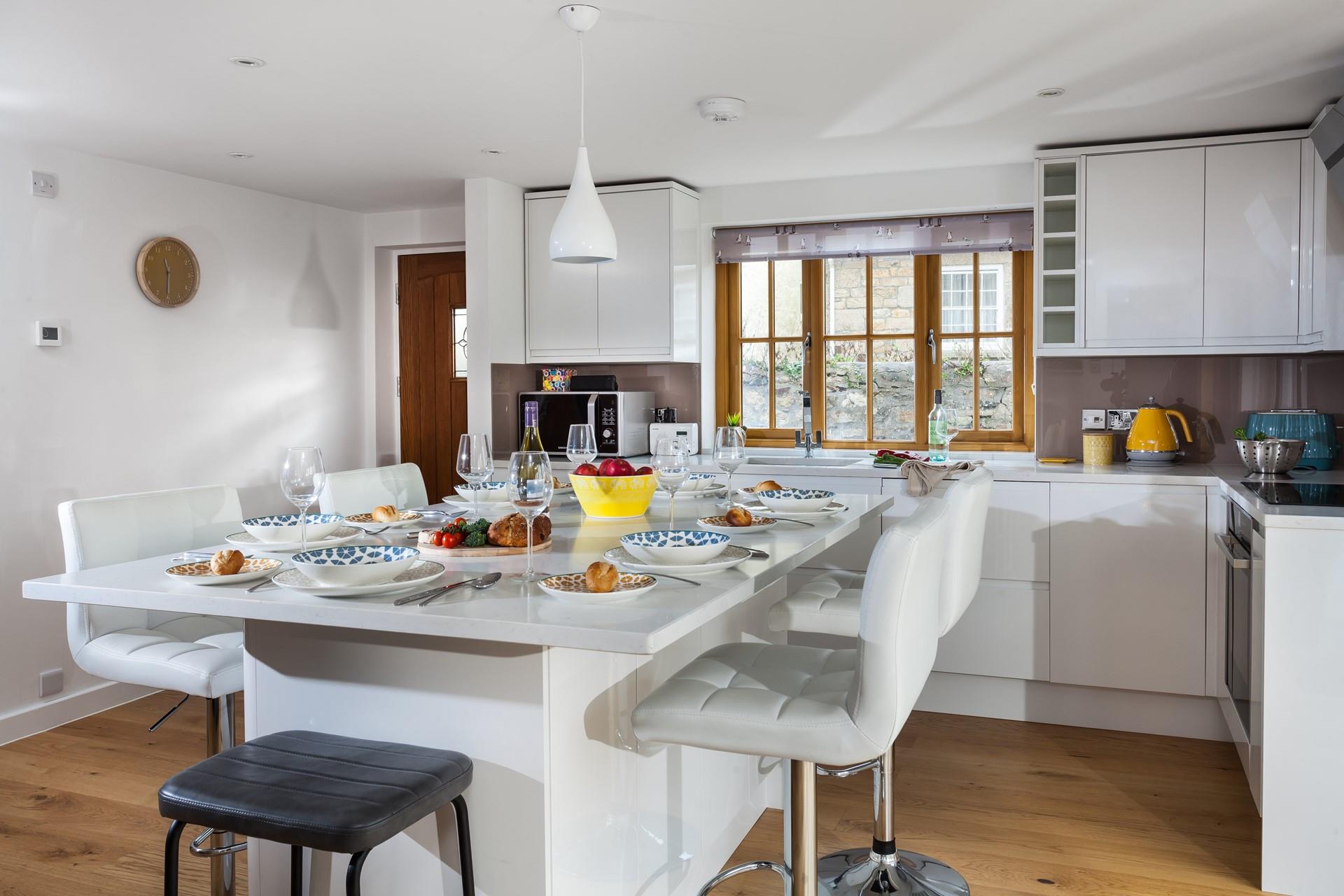 The modern kitchen has a large island for you to sit around on lazy mornings.