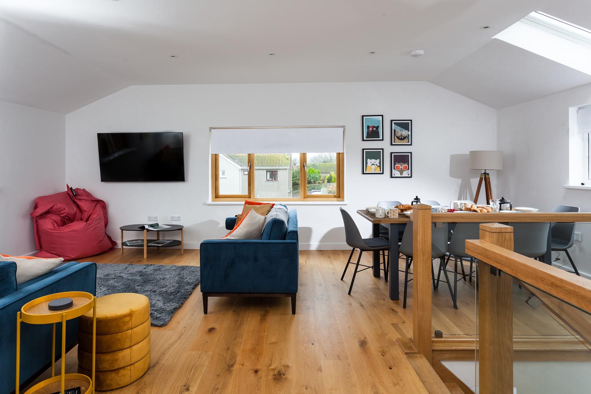 The open plan sitting/dining area is a cosy space for the whole family to relax in.