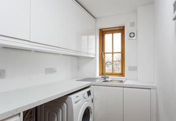 The utility room features a washing machine to wash all your beachwear.