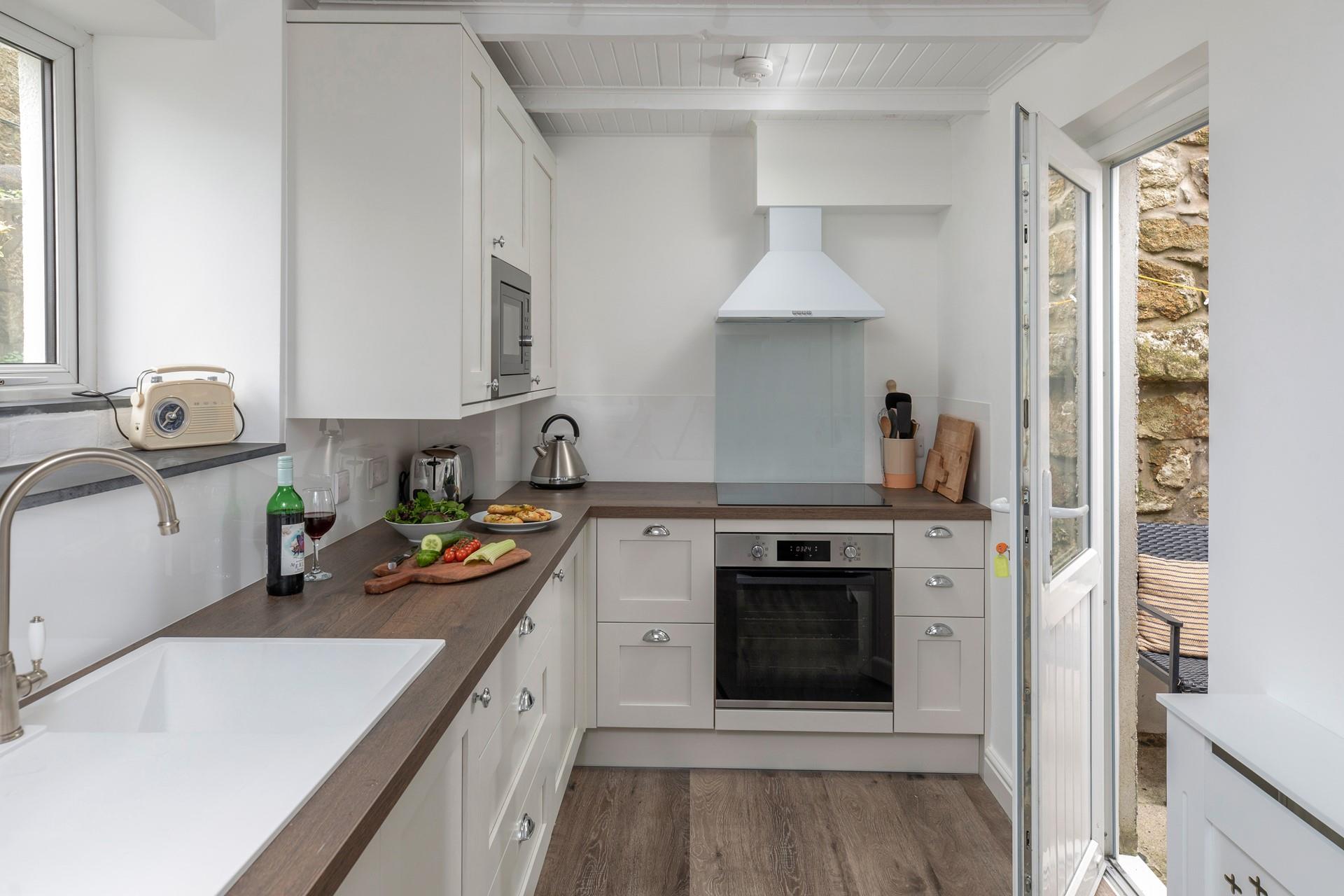 The modern well-equipped kitchen has all you need to cook up a storm at Primrose Cottage.