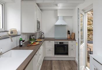 The modern well-equipped kitchen has all you need to cook up a storm at Primrose Cottage.