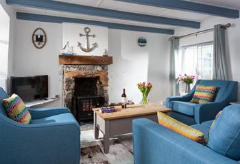 Snuggle up and enjoy a glass of wine and a good book in the colourful sitting room. 