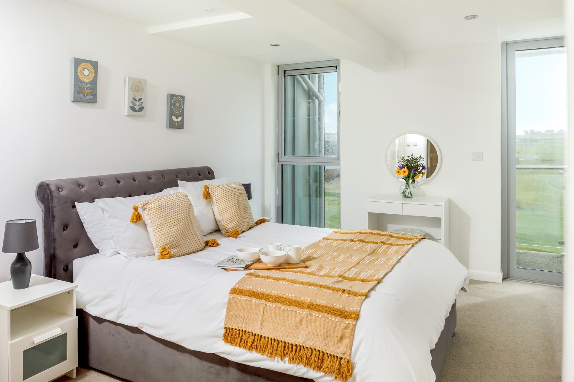 The master bedroom has a super comfortable king size bed and doors out to the second balcony.