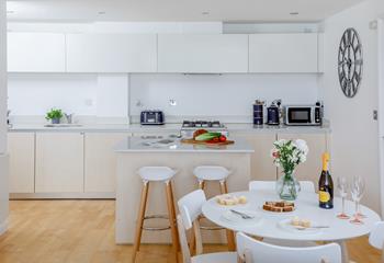 Crisp white walls and kitchen make a refreshing and light space.