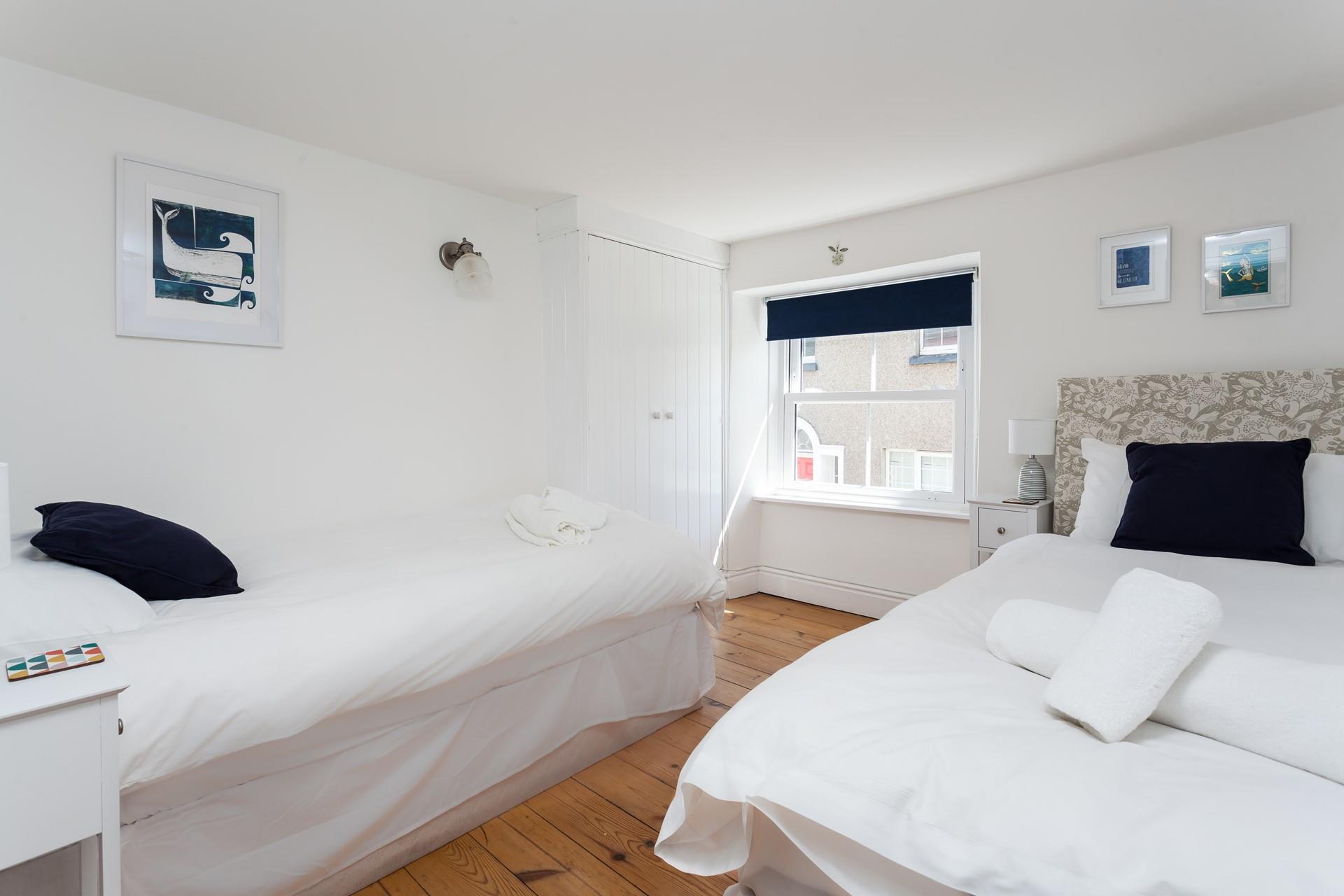 First floor twin bedroom with window to the front of the cottage.