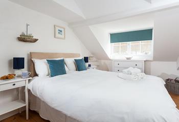 Peaceful master bedroom on the third floor, with sea views to the front.