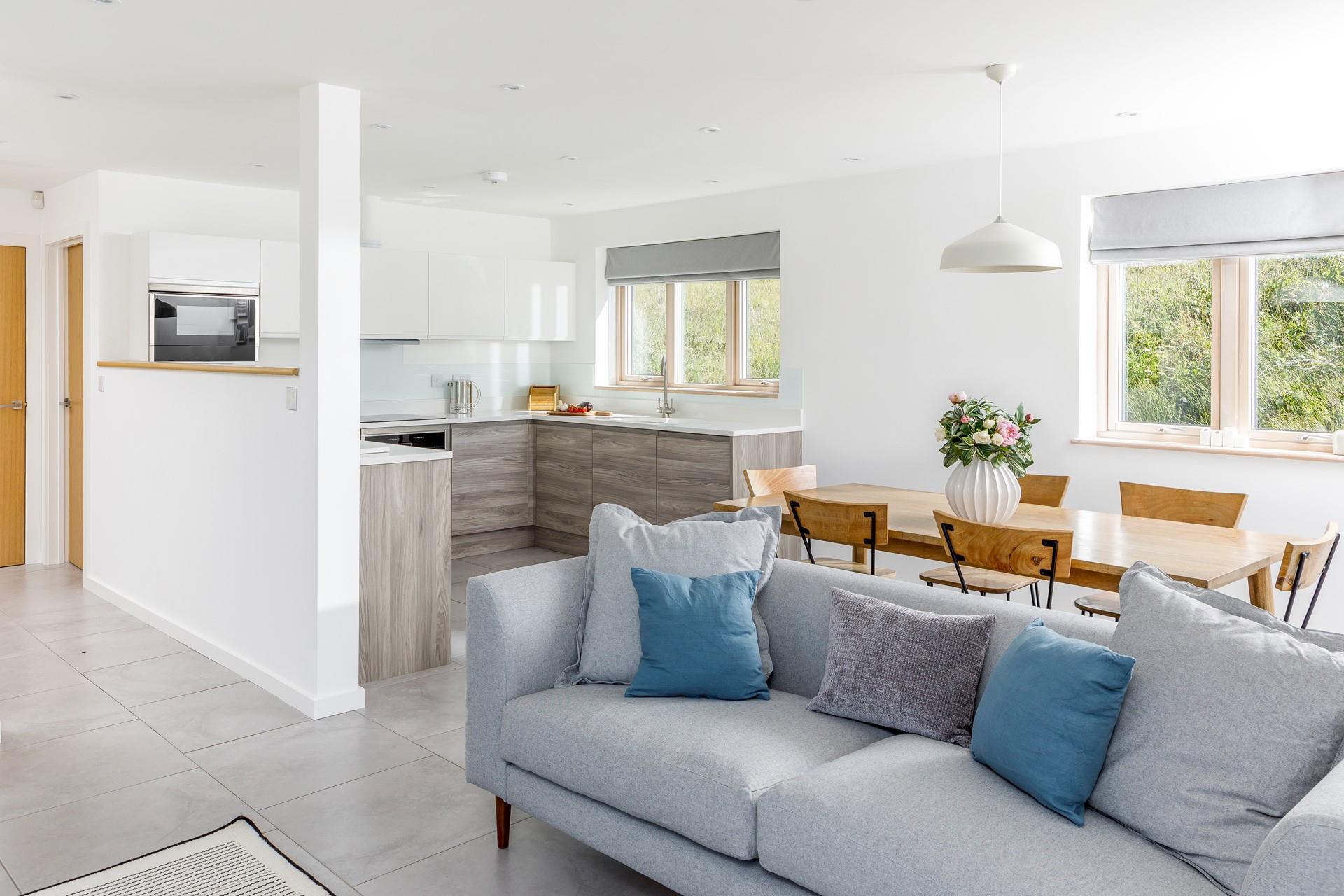 The open plan living space is spacious and light with room for the whole family to cook, dine and relax.