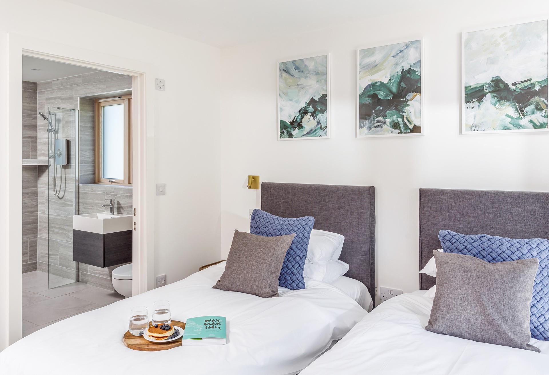 Bedroom 1 has a wet room with a walk-in shower and is decorated in seaside colours.