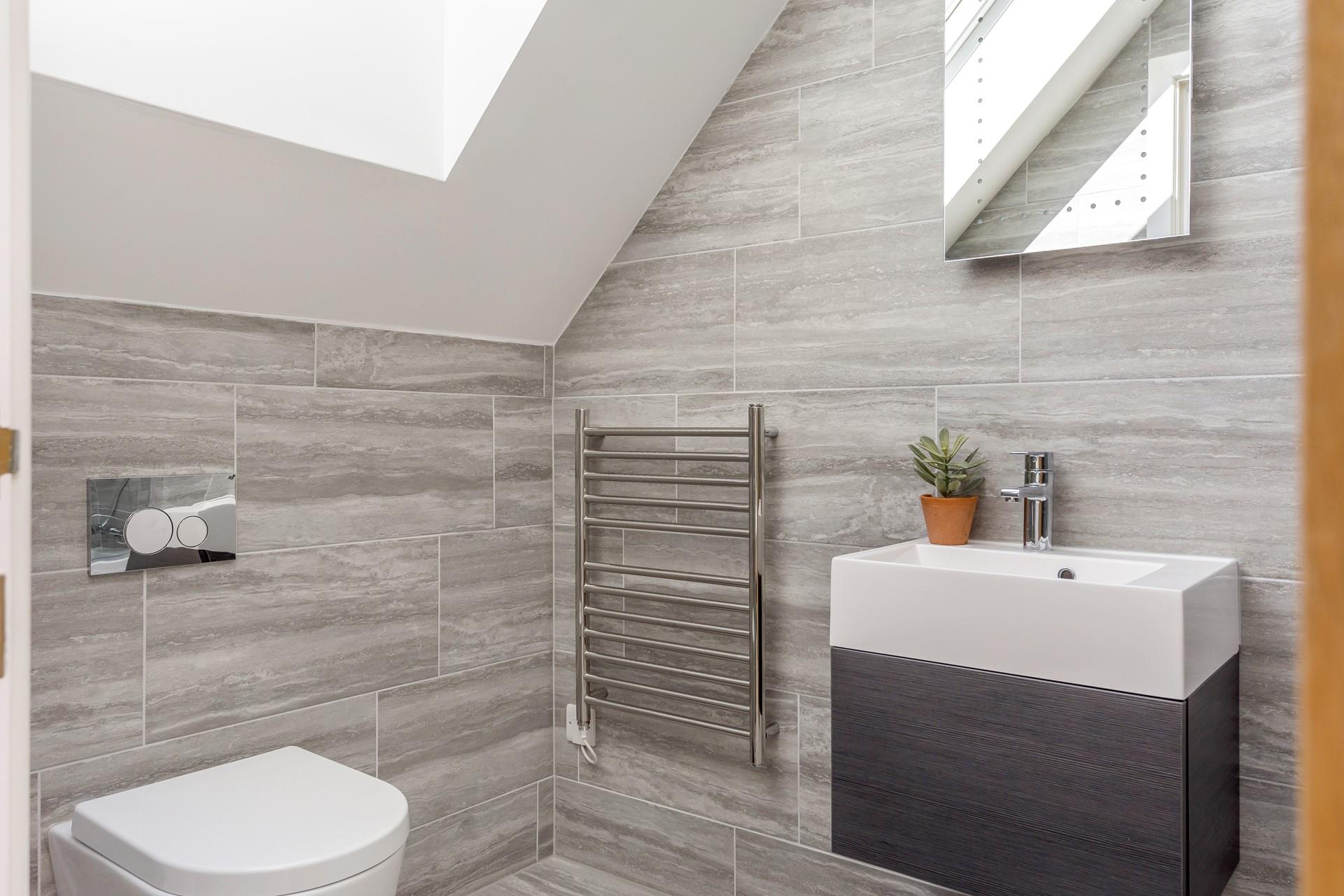 The bathroom has luxurious touches such as a light-up mirror and heated towel rails.